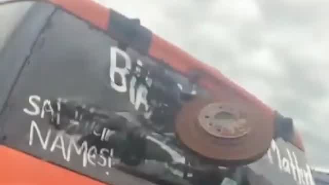 Chad throws a tire at a BLM sign
